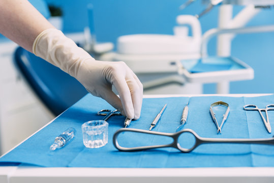 Detail Of Hand Holding Dental Tools In Dental Clinic.