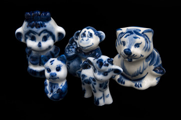 porcelain figurines on a black background