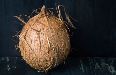 Whole coconut fruit on black background