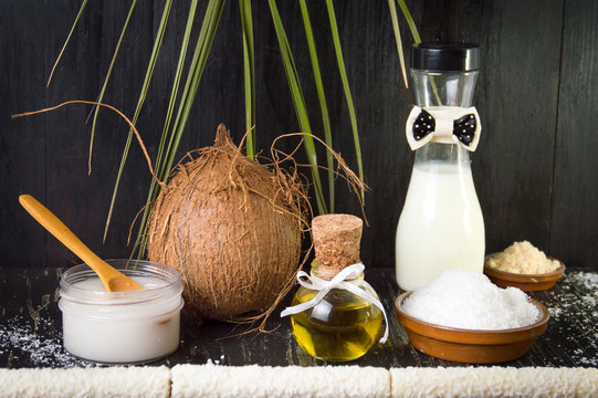 Various coconut products on black background