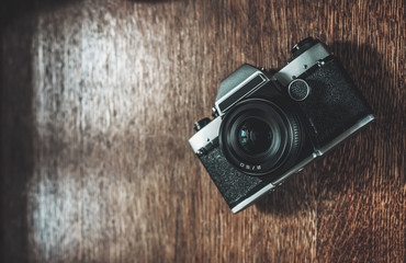 Retro camera on wooden table