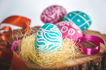 Naklejka na ściany i meble Closeup of beautiful Easter eggs with their hands. A festive mood. 