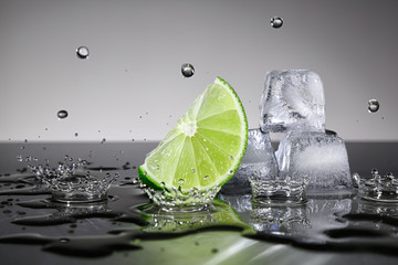 Lime with water drops and ice cubes