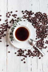A cup of coffee with coffee beans