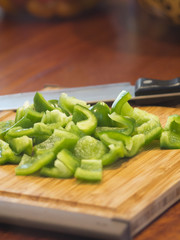 Diced Green Bell Pepper on Wooden Cutting Board