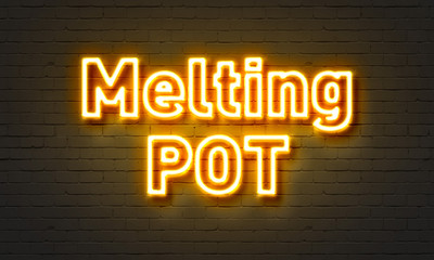 Melting pot neon sign on brick wall background.