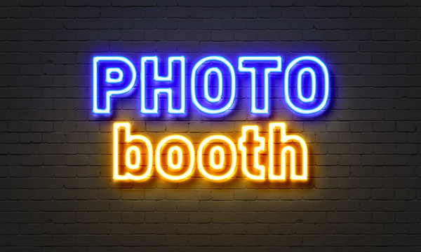 Photo Booth Neon Sign On Brick Wall Background.