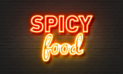 Spicy food neon sign on brick wall background.