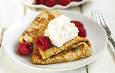 Crepes with raspberries and whipped cream