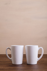 Mock-up mugs. Mockup coffee or tea cups. Design concept for branding. Front view. Wooden rustic board.