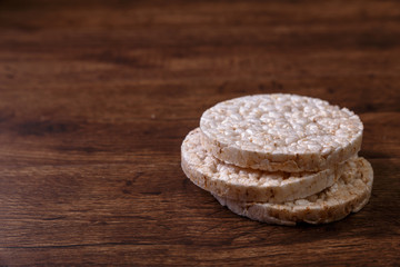 Rice biscuits on grunge rustic wood background. Natural organic diet food. Wooden vintage board.