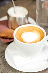 Coffee espresso in white cup and sugar on table