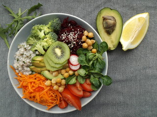 Vegetarian buddha bowl. Boiled barley and chickpeas, vegetables, raw and cooked