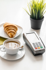 Credit card payment in cafe on white table background