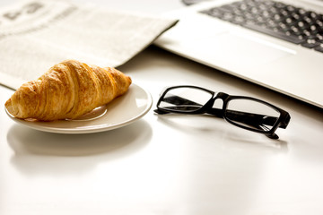 Office breakfast with laptop on white desk