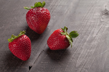Local fresh California strawberries on a dark wooden background horizontal shot
