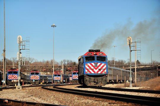 A Metra commuter train passing through a locomotive and equipment storage facility in Aurora, Illinois on its journey to Chicago. Metra provides an extensive network connecting suburbs to Chicago.