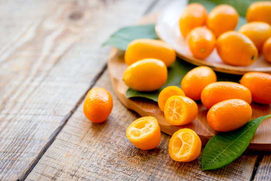 kumquat on plate at wooden table