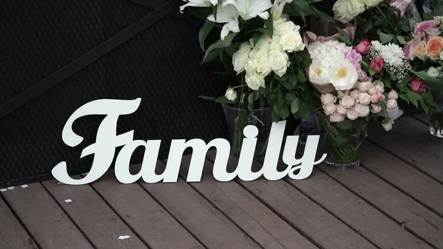 Family sign and flowers outdoors