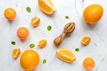 Fresh orange fruits with mint on table background top view pattern