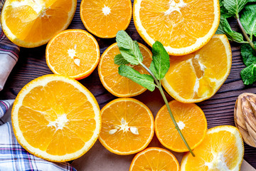 Orange juice making from fruit and mint on kitchen table top view