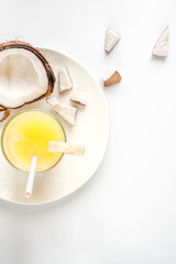 cocktail with coconut on white background top view