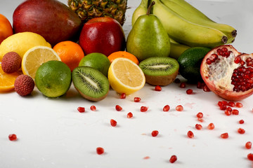 Fototapeta na wymiar Set of juicy ripe tropical fruits on a white surface