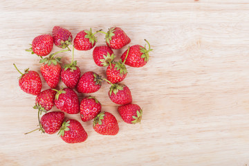 Fresh ripe strawberry on wood background
