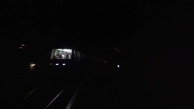 Metro underground tube subway tunnel POV from moving train to rails and station.