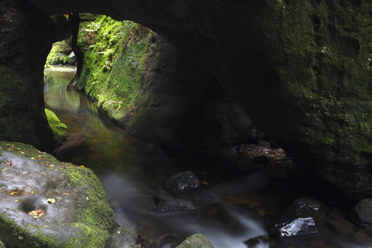 Krinice River flowing through rock tunnel, Kyov, Ceske Svycarsko / Bohemian Switzerland National Park, Czech Republic, September 2008