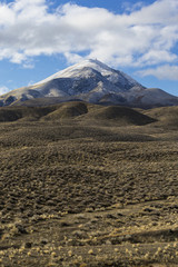 Naklejka premium Wide open empty desert landscape in Nevada during winter with blue skies and clouds. Mountains in the distance.