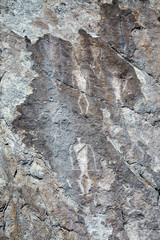 Ancient petroglyphs of dancing shamans with horns, rock paintings of ancient buryat tribe, lake Baikal coast