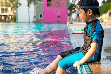 boy learn to swim in the swimming pool