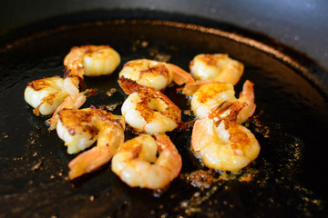 Fried shimps on frying pan, part of salad or another dish