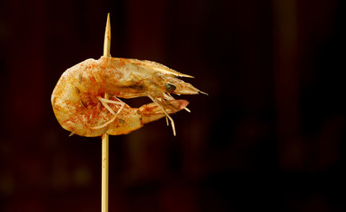 Raw shrimp on wooden skewer