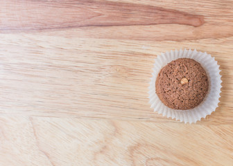 Cookies chocolate in plastic box on wood background