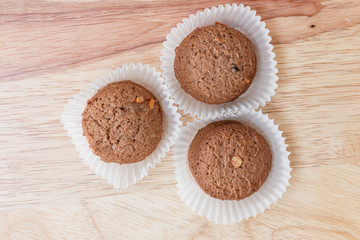 Cookies chocolate in plastic box on wood background