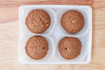 Cookies chocolate in plastic box on wood background