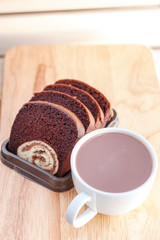 cake in dish and coffee on a wooden background