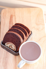 cake in dish and coffee on a wooden background
