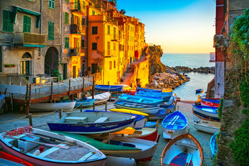 Riomaggiore village street, boats and sea. Cinque Terre, Ligury, Italy.