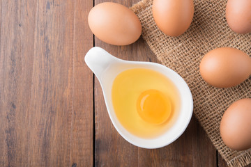 Fresh eggs on wood background. Top view