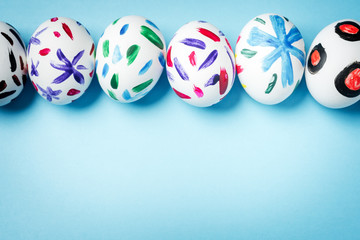 Easter bunny in a paper bag. Blue background. Easter ideas. Easter eggs. Space for text.