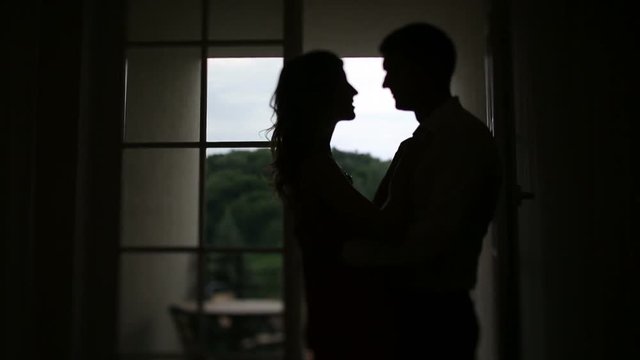 Couple is hugging and kissing. Man and woman undressing. I missed you so much, honey. Don't restrain passion.