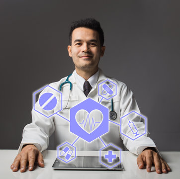Portrait of a medical doctor standing near a concrete wall with black and white round medical images. 