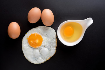 top view of fried eggs on black background, egg, Eggs in a bowl
