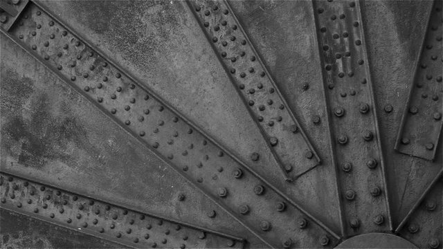 Surface of an old industrial machine covered Surface of an old industrial machine covered with bolts and screws

