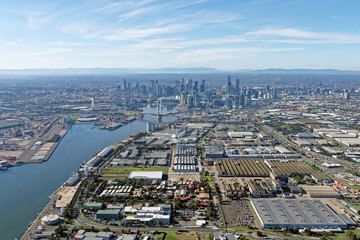 Naklejka premium Industrial Melbourne: Docklands and CBD skyline viewed from above Port Melbourne