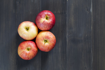 Fresh apples for health on the wooden background.