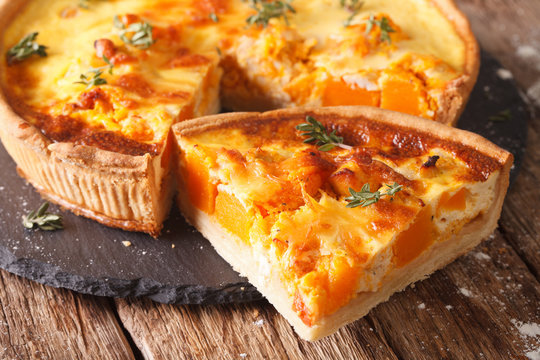 Fototapeta Quiche with pumpkin, cheese, chicken and herbs closeup. horizontal